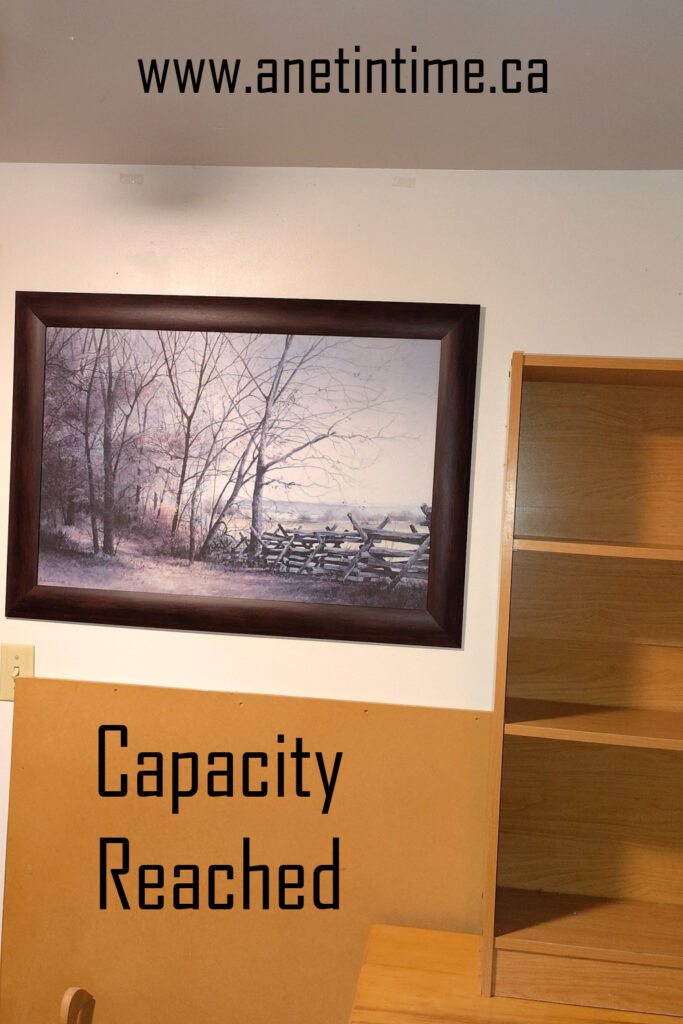 text: capacity reached
image: picture mounted on a wall