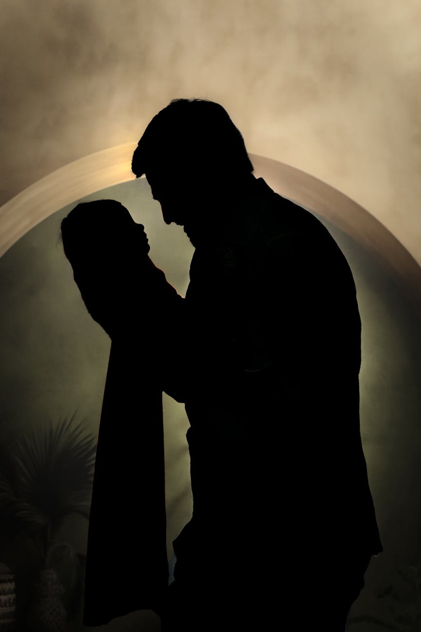 father holding baby silhouette at sunset
