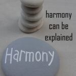 harmony can be explained, text over stacked rocks