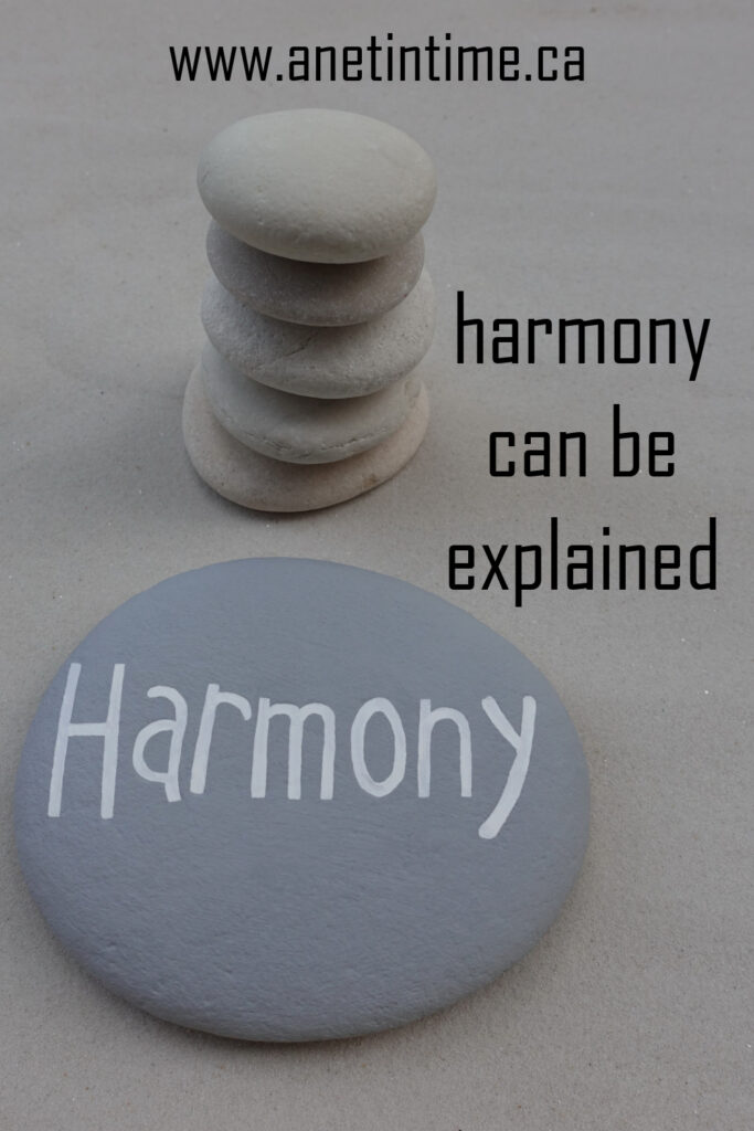 harmony can be explained, text over stacked rocks