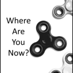 image of black fidgit toy spinner. Text where are you now?