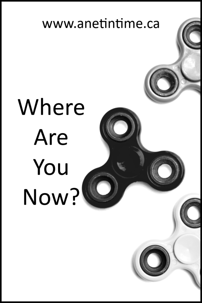image of black fidgit toy spinner. Text where are you now?